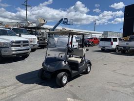 A 2019 Yamaha G29 E Electric Golf Car with a black body and beige seats parked in a lot