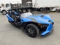 A blue 2020 Polaris SlingShot three-wheeled vehicle with a sleek design and two seats, featuring a prominent front end and sporty wheels