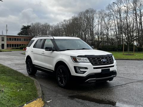 A white 2017 Ford Explorer is parked with a sleek design featuring black accents and a modern front grille