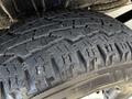 Close-up of a black tire with deep treads mounted on a 2012 Mercedes-Benz Sprinter showing detailed patterns for traction and grip