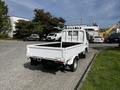 A white 2004 Toyota Toyoace pickup truck with a flatbed design parked on a driveway