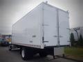 A white 2021 Mack MD truck with a closed rear cargo door and a silver step at the back