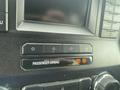 Dashboard controls of a 2017 Ford F-550 with buttons for passenger airbag status and other vehicle settings