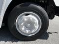 Close-up of a white wheel with a shiny hubcap and a black tire on a 2009 Morgan Olson Workhorse