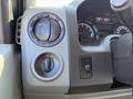 Close-up of the control panel in a 2011 Ford Econoline featuring knobs for air conditioning and other vehicle functions