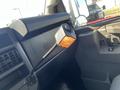 A 2016 Chevrolet Express interior with a flexible gooseneck light mounted on the dashboard illuminating the area near the driver's seat
