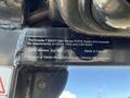 A label on a Kubota F3990 tractor detailing compliance with safety requirements and listing the serial number and manufacturer information