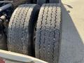 A pair of worn tires from a 2022 Freightliner Cascadia with visible tread wear and distinct patterns on the rubber surface
