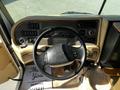 Interior view of a 2000 Ford Motorhome dashboard featuring a steering wheel controls and various dials and buttons