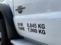 A white 2016 Ford F-550 with a power stroke badge and visible weight specifications on its side indicating GVW 8845 KG and TARE 7000 KG