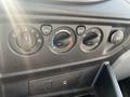 A dashboard control panel from a 2016 Ford Transit featuring dials for climate control and a 12V power outlet