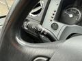 Close-up of a 2011 Ford F-650 steering wheel displaying controls for indicators and wipers with gauges visible on the dashboard