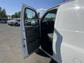 A white 2013 Chevrolet Express van with an open driver's side door revealing the interior including the seats and steering wheel