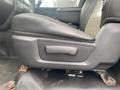 Close-up of the driver's seat in a 2011 Dodge Ram 5500 showing the armrest and seat adjustment controls