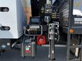 A 2012 Freightliner M2 112 with visible hydraulic controls a HIAB hydraulic system and various connecting hoses and electrical components