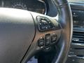 Close-up of the steering wheel controls of a 2013 Lincoln MKT featuring buttons for navigation audio and phone functions