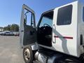 A 2007 International 7300 truck with the driver's door open showcasing the interior and steering wheel