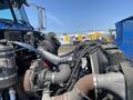Close-up view of the engine components of a 2008 Peterbilt 340 including pipes and hoses with a focus on the turbocharger and manifold system