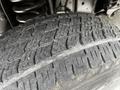 Close-up of a worn tire from a 2018 Ford Econoline showing tread patterns and wear characteristics