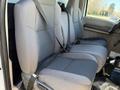 Interior view of a 2009 Ford F-550 showing two gray front seats with seatbelts attached
