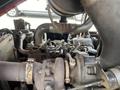A 2014 Toro Groundmaster 5910 showing its engine components including pipes and valves with visible wear and grease
