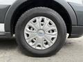 A close-up of a silver wheel rim with a five-spoke design mounted on a black tire labeled 235 65 R16