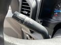 Close-up of a turn signal and windshield wiper control stalk on a steering column of a 2017 Ford F-250 SD