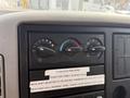 Dashboard controls of a 2011 International 4300 featuring knobs for climate control and indicators for brake and transmission settings