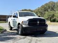 A white 2019 RAM 1500 Classic pickup truck facing forward with a black grille and bumper showcasing a rugged design and chrome wheels