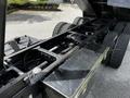 Close-up view of the chassis of a 2010 Freightliner M2 106 with visible dual rear tires and a stainless steel fuel tank