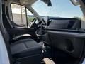 Interior of a 2022 Ford Transit showing driver's seat steering wheel dashboard and console with touchscreen display