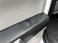Close-up of a door control panel featuring a window switch on a 2020 Ford F-350 interior