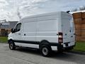 A white 2017 Mercedes-Benz Sprinter van parked on a concrete surface with a high rooftop and sliding side door