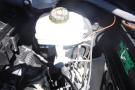 A close-up view of the brake fluid reservoir in a 2012 Mercedes-Benz Sprinter showing the cap and connected hoses