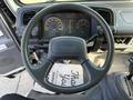 The interior view of a 2007 GMC W5500 18 Foot Cube Van showing the steering wheel dashboard and instrument cluster