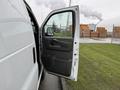 A 2014 GMC Savana van with the driver's side door open showcasing the interior door handle and panel
