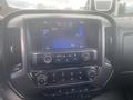 A dashboard display of a 2015 Chevrolet Silverado 3500HD showing radio controls and a touchscreen interface with various buttons and settings