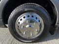 A close-up of a chrome wheel rim and tire from a 2017 Ford Transit showing the intricate design of the rim and tire tread pattern