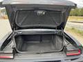 A 2017 Dodge Challenger with its trunk open revealing the spacious interior and carpet lining