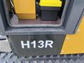 A 2024 AGT Industrial Yellow H13R Mini Excavator with a visible H13R label and service access door in the foreground