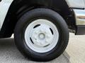 Close-up view of a white tire on a 2010 Ford Econoline featuring a distinctive rim design and tread pattern