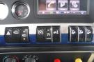 Dashboard controls of a 2015 Kenworth T660 featuring various buttons for settings audio and additional functions