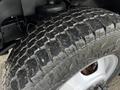Close-up of a tire from a 2017 Chevrolet Express showing deep treads and rugged surface texture