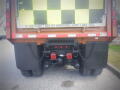 Rear view of a 2016 International WorkStar 7500 truck showcasing dual tires and mounted lights on the chassis with a warning sign on the back