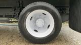 A close-up of a white wheel with a black tire on a 2021 International CV515 truck