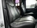 Two black leather seats in a 2006 GMC C5000 with a slightly worn appearance