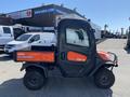 2018 Kubota ATV in orange and black with a covered cargo bed and large wheels suitable for off-road driving