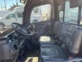 Interior view of a 2014 Kubota X1100C featuring two black seats a steering wheel and various controls