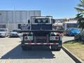 A 2018 International DuraStar truck with a flatbed and visible rear lights parked in a lot
