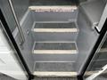 Stairs leading into a 2015 Spartan School Bus with non-slip treads and a handrail